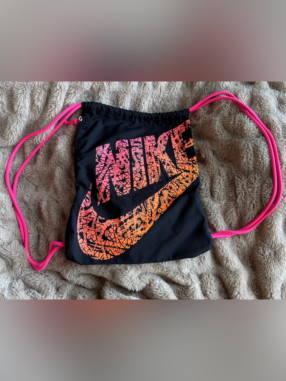 Nike Black Drawstring Backpack with Pink-to-Orange Gradient Logo